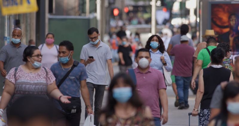 NEW YORK - CIRCA AUGUST 2020: Crowd of people wearing a mask walking street during coronavirus pandemicNEW YORK - CIRCA AUGUST 2020: Crowd of people wearing a mask walking street during coronavirus pandemic