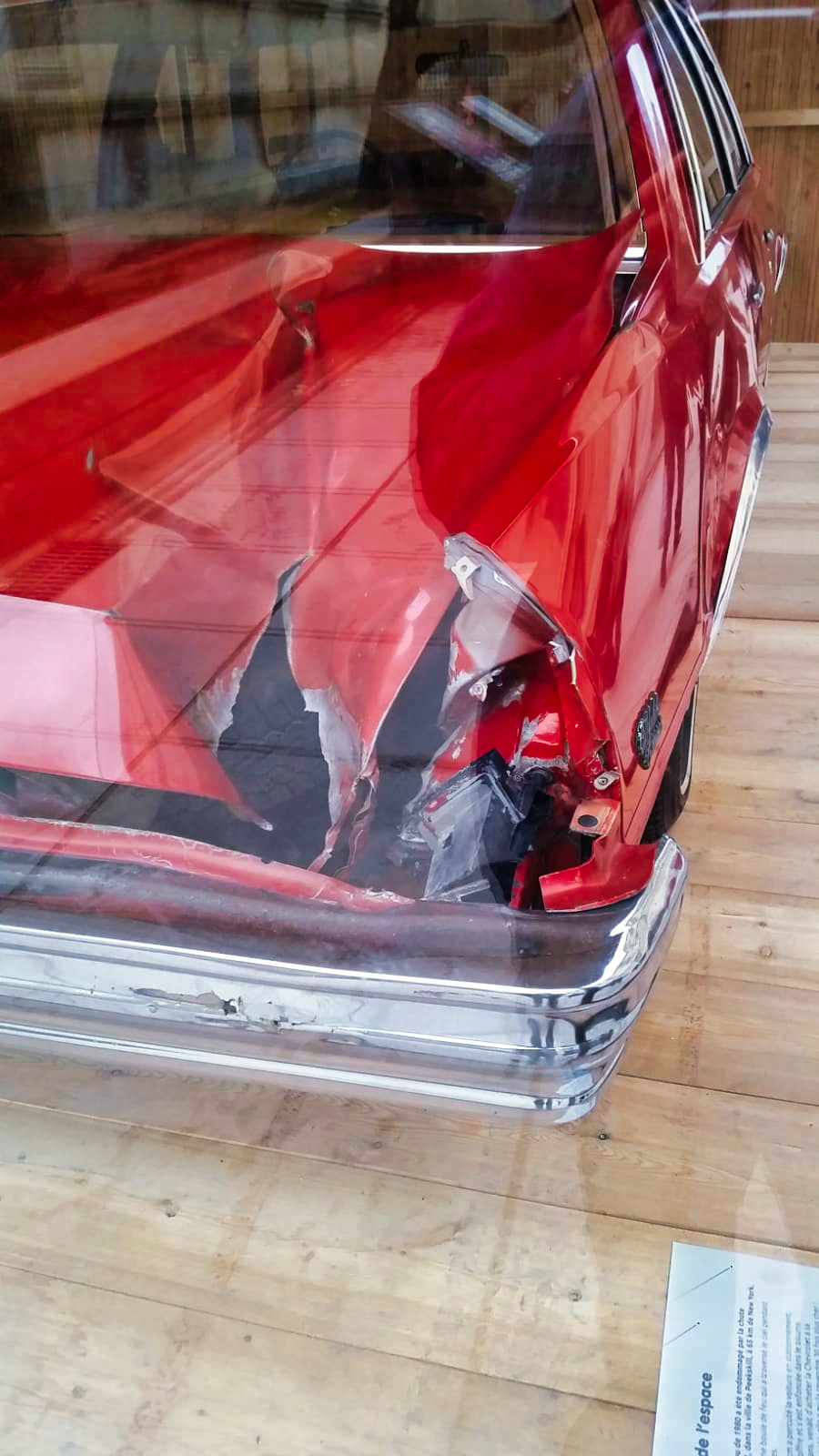 A picture of the red Chevy with a huge hole in its trunk. A picture of the red Chevy with a huge hole in its trunk.