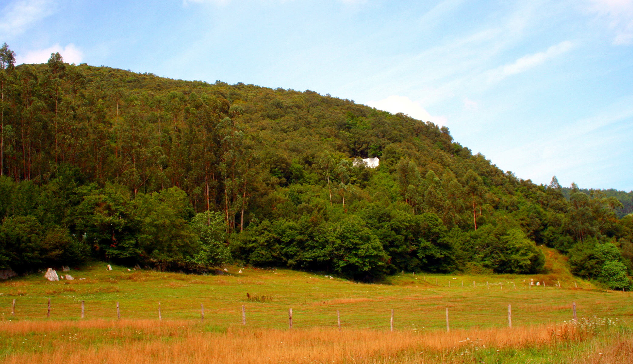 Approach to La Garma cave, entrance covered by a white sheet Approach to La Garma cave, entrance covered by a white sheet