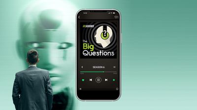 A picture of a man staring at a robot face, over laid with a mobile phone that has the big questions logo on it.