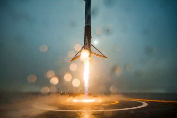 the first stage of a Falcon 9 rocket returns to Earth.