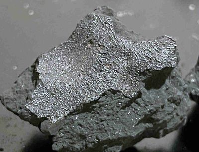 a shiny grey jagged rock is visible in this image