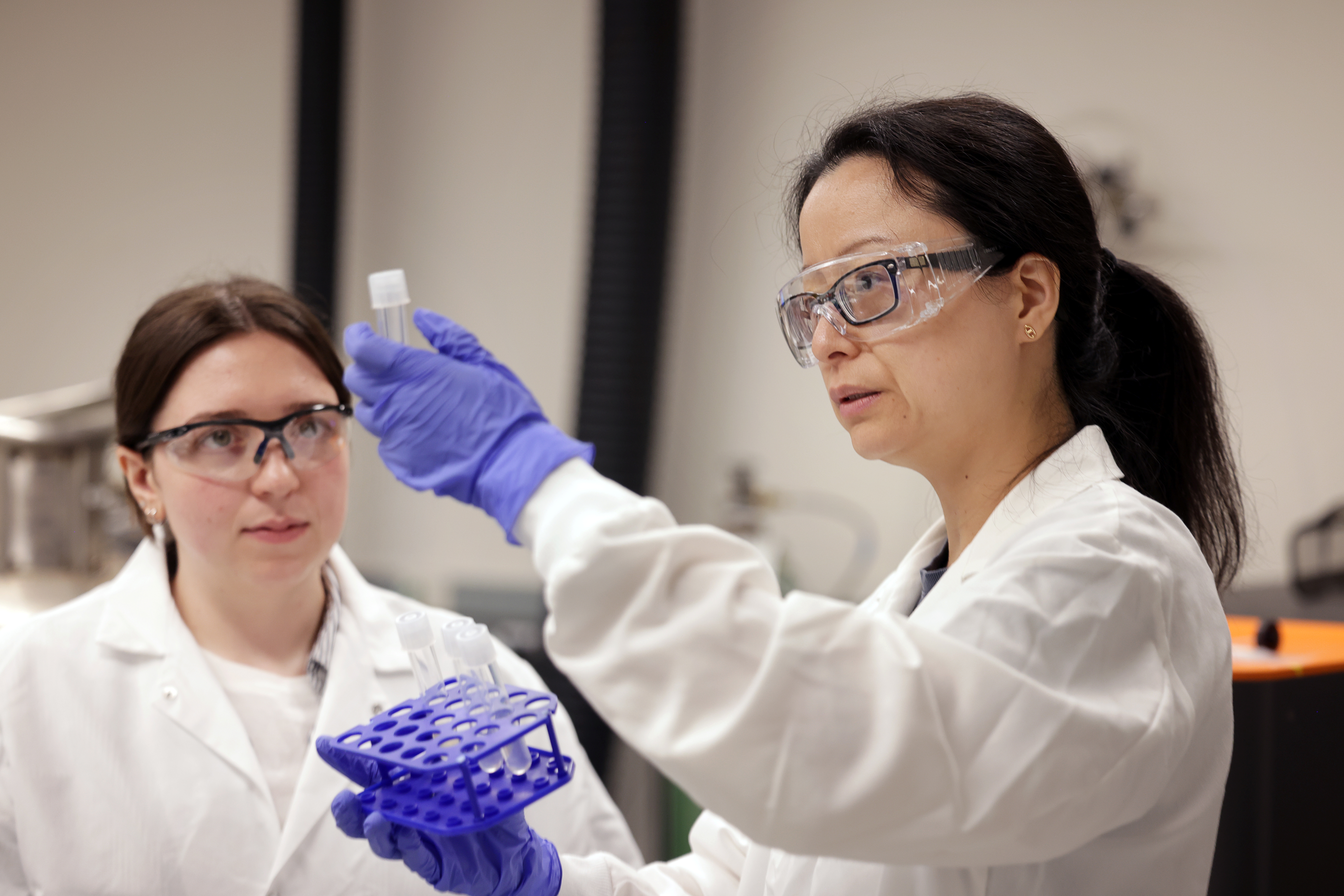 two scientists in the lab examining a test tube two scientists in the lab examining a test tube