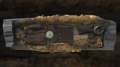 A picture of the Egtved Girl burial as it now is, showing the furs and clothing within a log coffin.