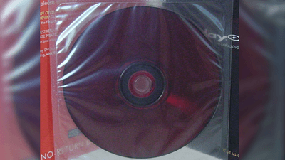 A Flexplay DVD: A dark red DVD disk inside a plastic bag.