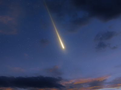 a fireball in the evening sky, appearing among some clouds