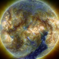 the sun in ultraviolet wavelenghts with a clear chunk of the sun atmosphere missing where the coronal hole is