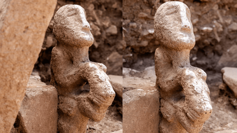 An ancient carving of a human figure sitting on a leopard.