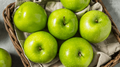 Granny smith apples, looking particularly green and crisp.