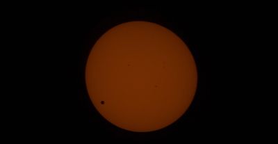 The existance of a large moon around Venus would create a thrilling sight at many times, but never more than during transits of Venus like the one photographed here.