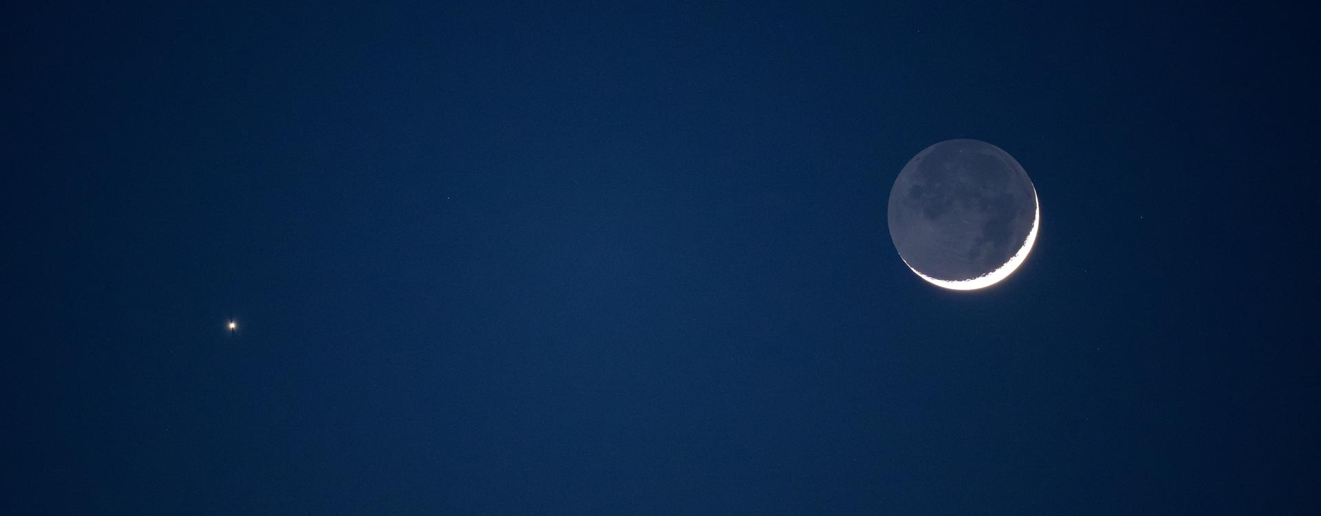 Venus and the crescent Moon photographed over NASA's headquarters in Washington. Imagine if there was a dot representing Venus's own moon next door.