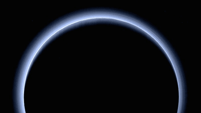Sunlight behind Pluto: A thin disk of blue light seen behind the dwarf planet.