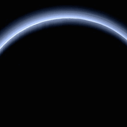 Sunlight behind Pluto: A thin disk of blue light seen behind the dwarf planet.