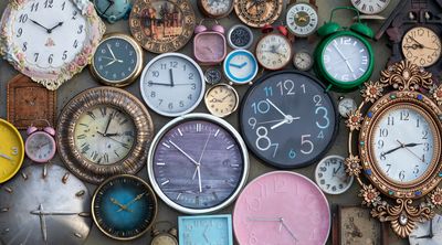 a wall filled with different time of clocks all with different times