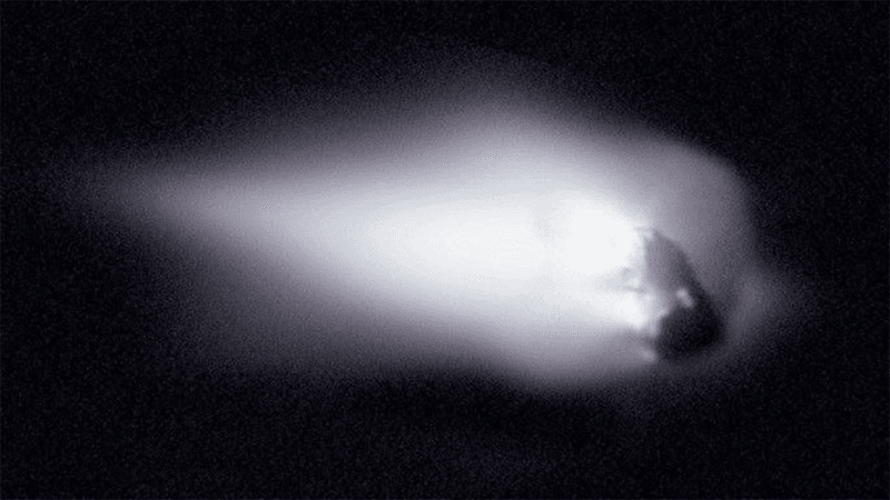 Halley's Comet, seen in the closest view humanity has ever had. It looks like a rock protruding from a cloud.