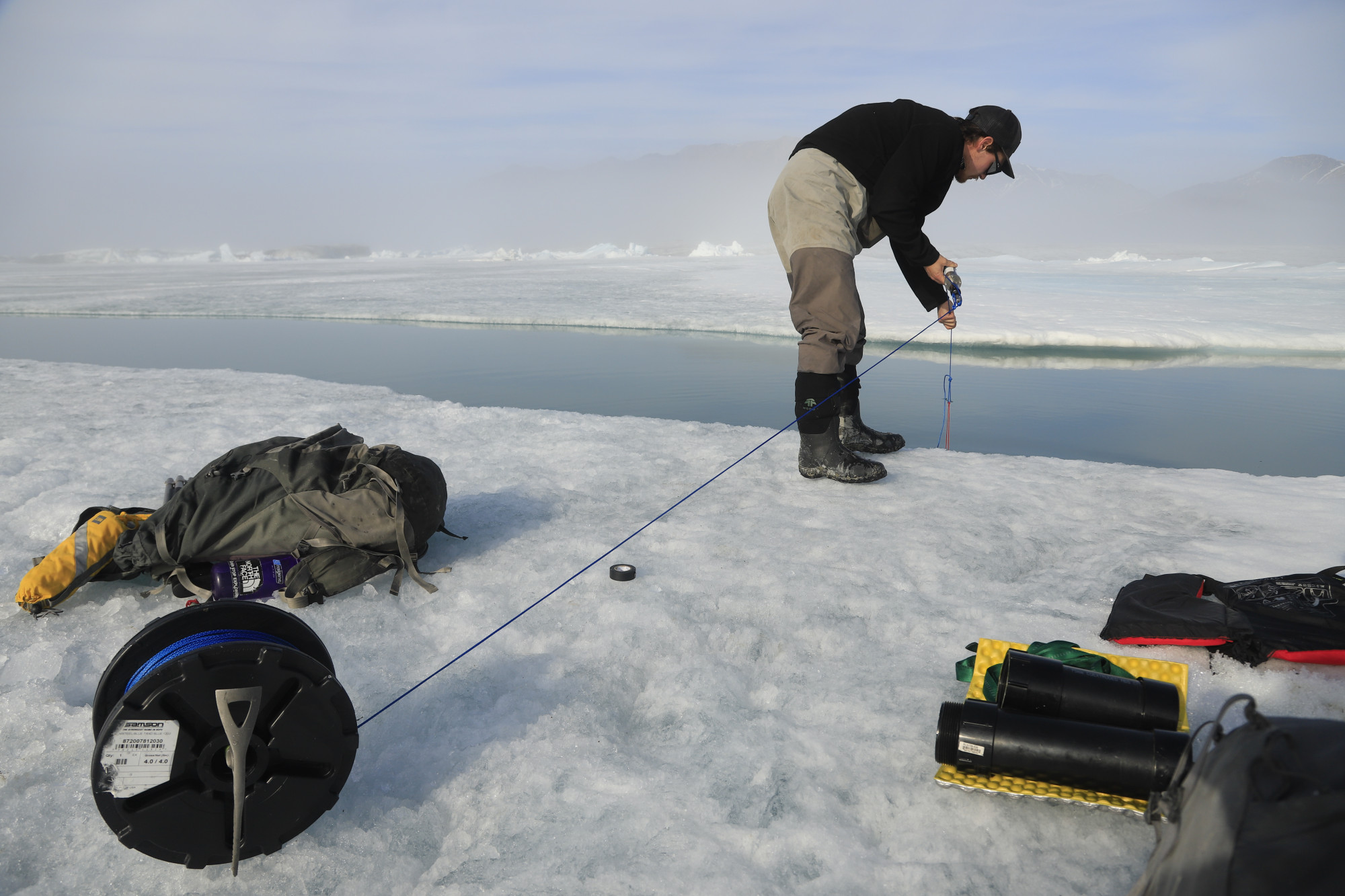 Jérémie Bonneau testing water salinity and temperature at the rift that formed in the Milne Ice Shelf after the 2020 collapse. Jérémie Bonneau testing water salinity and temperature at the rift that formed in the Milne Ice Shelf after the 2020 collapse.