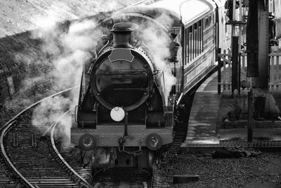 a black and white pothograph of a stream train