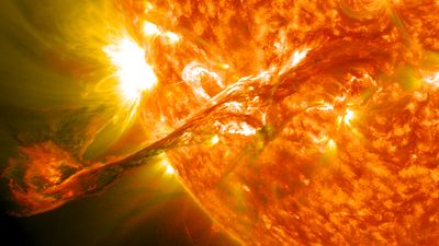 a partial view of the Sun showing a large plasma filament and a bright region at the rim of the solar disk