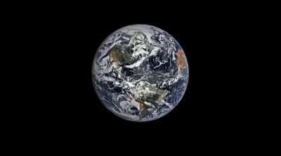 A picture of planet Earth from space showing clouds swirling with wildlife smoke.