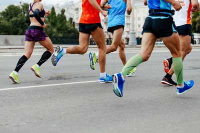 A picture of a group of people running, cutting them off at the waist.