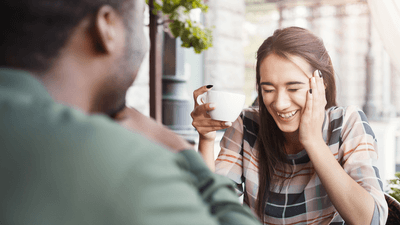 A man and a woman drinking hot drinks, on a date.