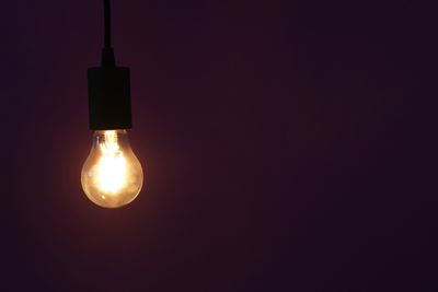 A single naked lit light bulb.