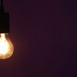 A single naked lit light bulb.