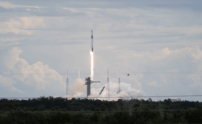 The rocket is in mid-air just above hte launch platform