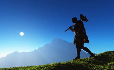 Ancient people against the evening landscape.