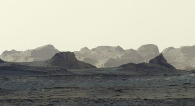 the nearby crags and distant peaks seen by curiosity as the sky looks white