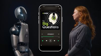 A picture of a woman standing opposite a humanoid robot, either side of a phone displaying the big questions logo.