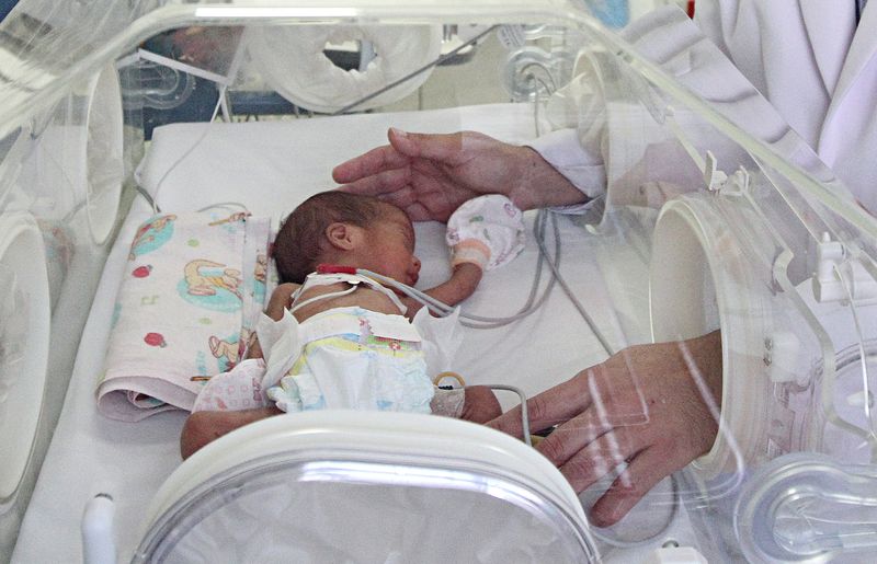 A premature baby in an incubator.