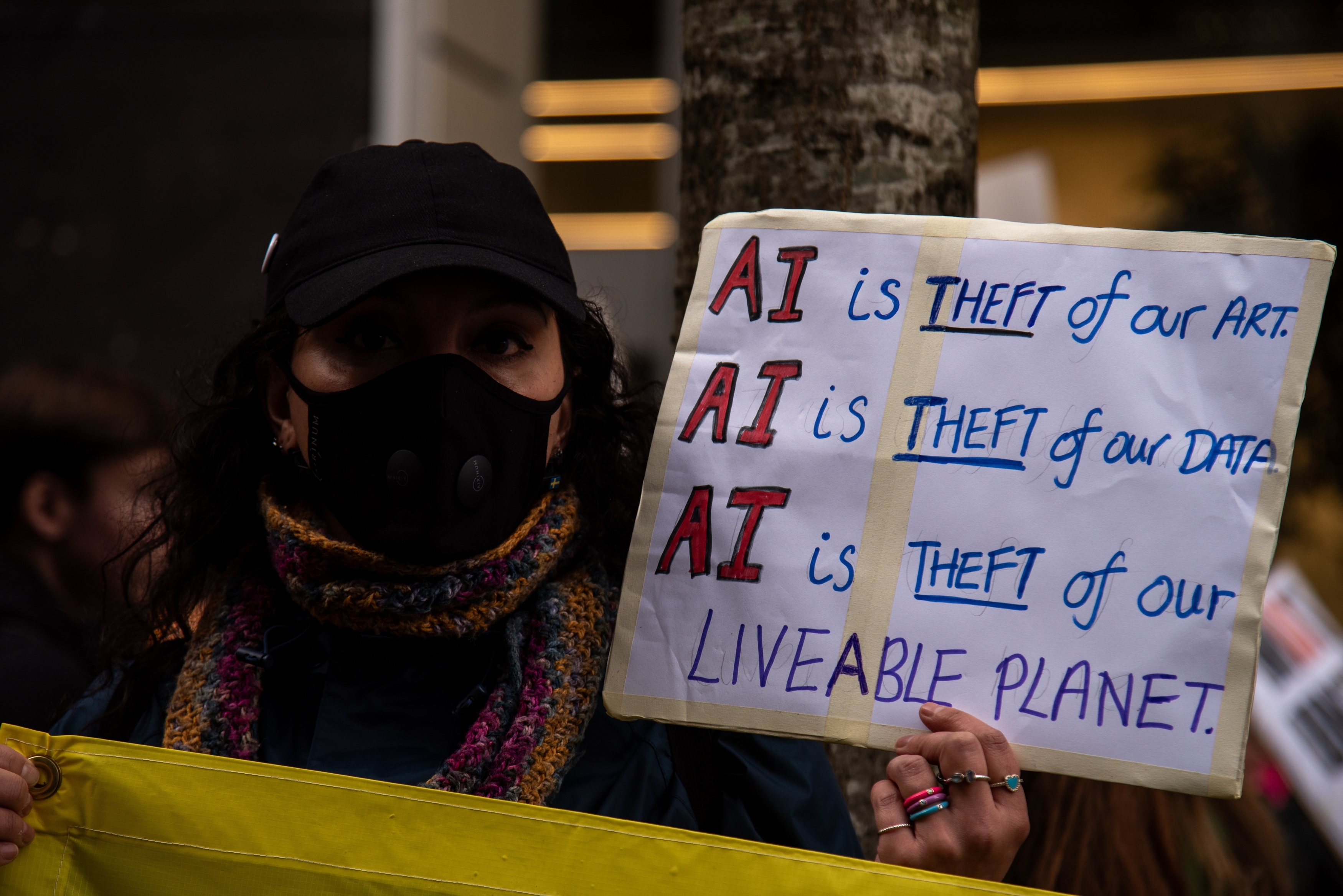 London, England, UK - February 28, 2026: A protestor holds a placard during the ‘March Against The Machines’ Protest. London, England, UK - February 28, 2026: A protestor holds a placard during the ‘March Against The Machines’ Protest.