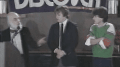 Three magicians standing on a stage.
