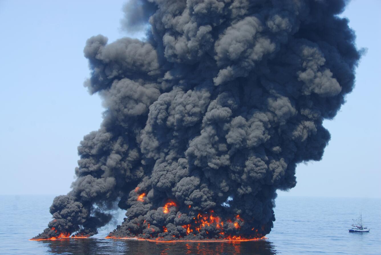 A controlled burn of oil from the Deepwater Horizon/BP oil spill sends towers of fire hundreds of feet into the air over the Gulf of Mexico. U.S. Coast Guard Photo by Petty Officer First Class John Masson.