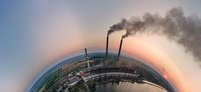 a coal power plant bellows out smoggy emissions.